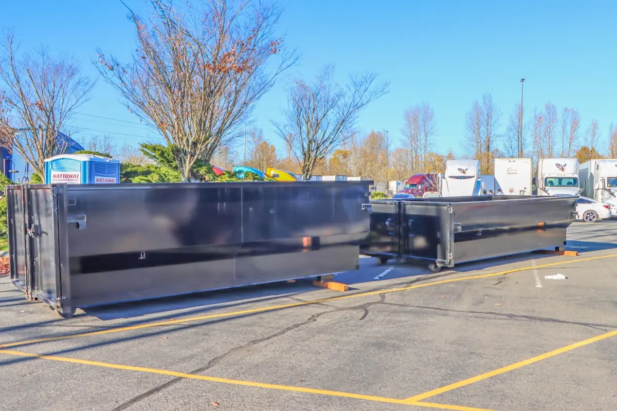 Professional dumpster rental service with roll-off container on residential driveway in Buckeye